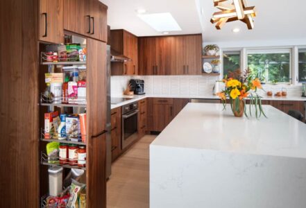 Pull out pantry drawer with medium-dark wood grain from Decor Cabinets.