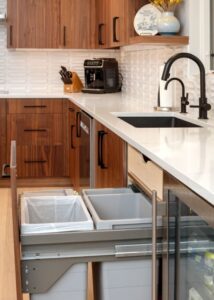 Pull out cabinet organizers with two trash cans.