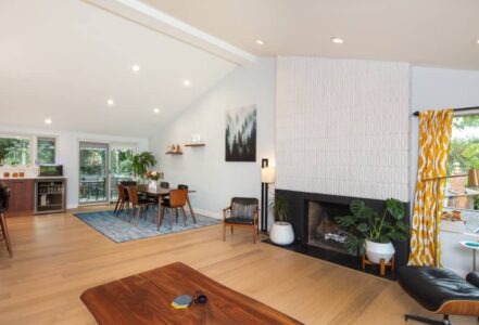 Living room space with a reshaped and reclad fireplace with mid-century-inspired Heath Ceramics tile.