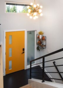 Matte black high-visibility stair railing gong down to a front door.