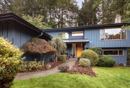 Two story home in West Lake Sammamish with blue siding and an orange door.