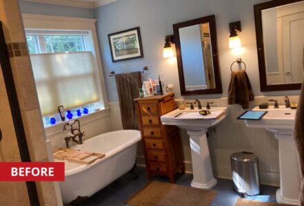 Clawfoot tub underneath a bathroom window.