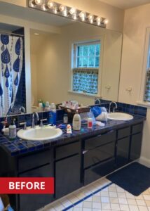 Double sink bathroom vanity with a blue square countertop and pull out drawers below.