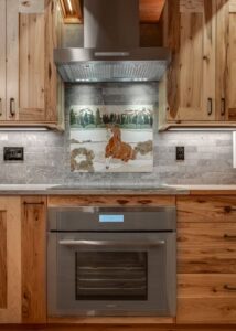 Induction stovetop with a stainless steel air vent above.