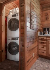 Stacked front-load washer and dryer in a laundry room.