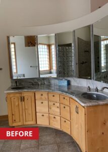 Curved bathroom countertop with two sinks and mirrors above.