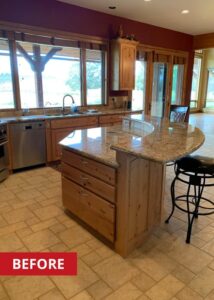 Two tier kitchen island with granite countertops.