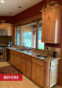 Two tier kitchen island with granite countertops.