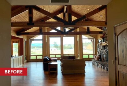 Living room with high ceilings and a stone fireplace.