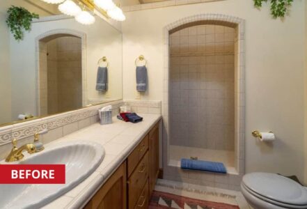 Bathroom with white tile walls and a walk-in shower.