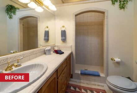 Bathroom with white tile walls and a walk-in shower.