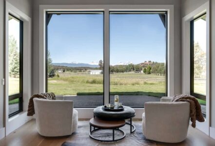 Seating area looking out of two large windows.
