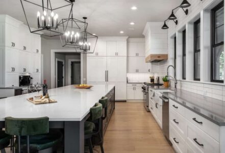 Kitchen island with Decor cabinets and three hanging lights above.