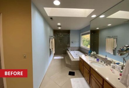 A bathroom vanity, bathtub, and shower all along a bathroom wall.