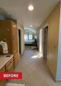 Hallway that leads from a primary bath too a bedroom.