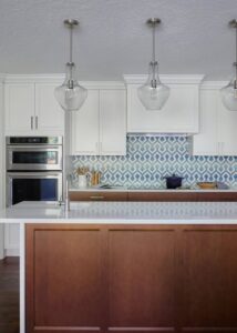 Wall oven built into white Decor kitchen cabinets to the left of a countertop.