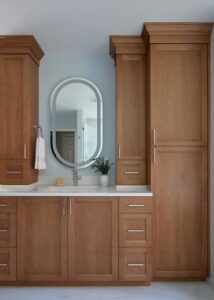 Natural wood dressing table in a primary bathroom.