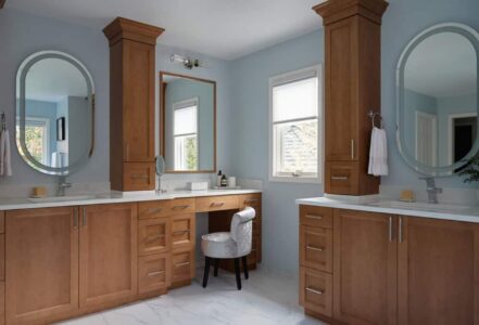 Natural wood dressing table in a primary bathroom.
