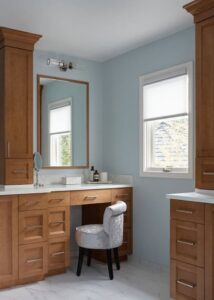 Natural wood dressing table in a primary bathroom.