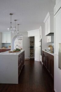Open floor plan transitional kitchen with pantry door open
