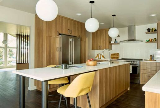 Kitchen with pendant lighting, wood cabinets, and hardwood floor.