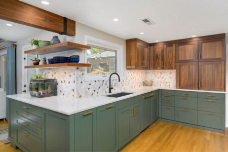 A remodeled kitchen with green and walnut cabinets
