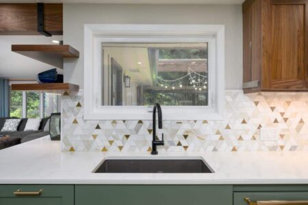 A remodeled kitchen with a geometric mosaic tile backsplash