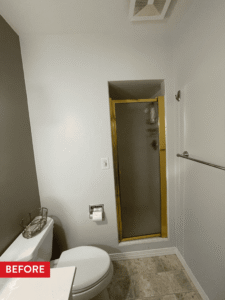 A cramped coffin-style shower before remodeling