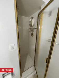 A cramped coffin-style shower before remodeling